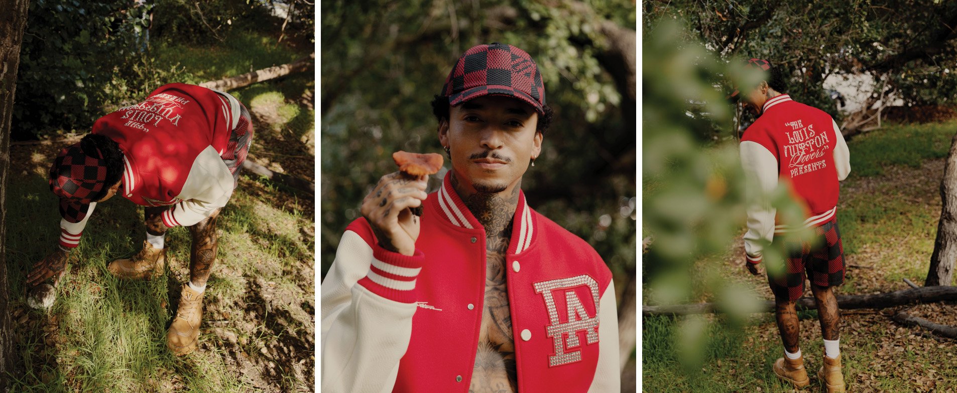 Man in red Louis Vuitton varsity jacket holds mushroom in outdoor fashion shoot in natural light among trees. Checkerboard hat detail.