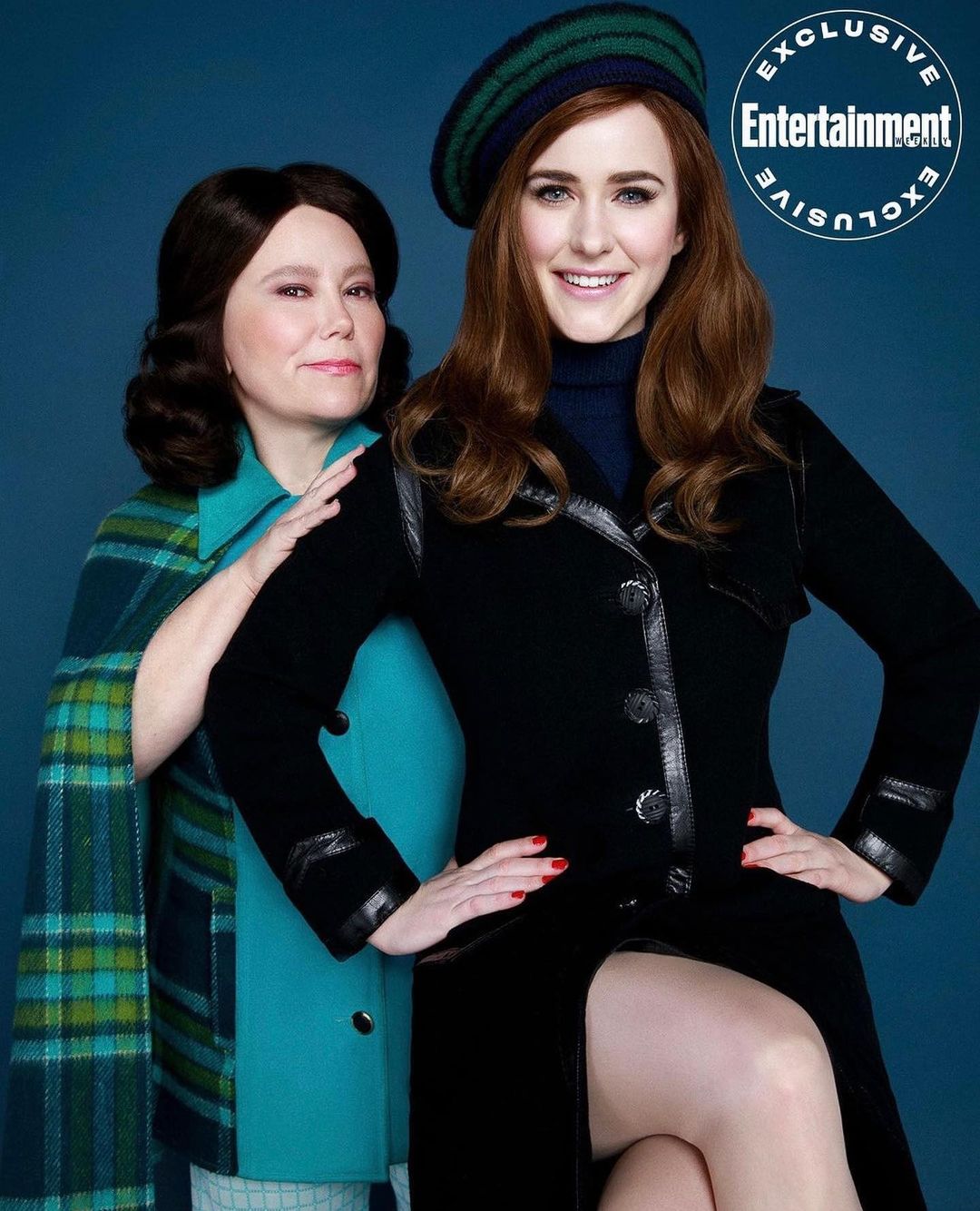 Two women pose indoors for an Entertainment Exclusive promotional shot. The woman on the right wears a black dress and beret.