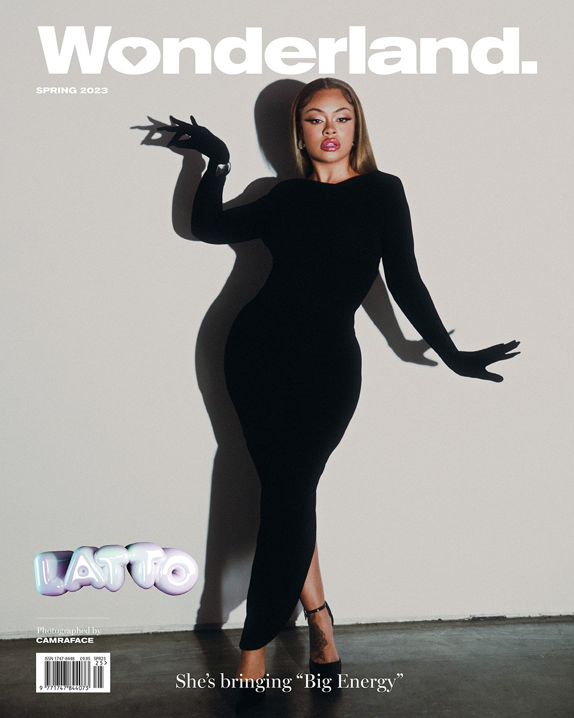 Wonderland magazine cover featuring an adult woman in a black dress and gloves posing against a light grey backdrop.