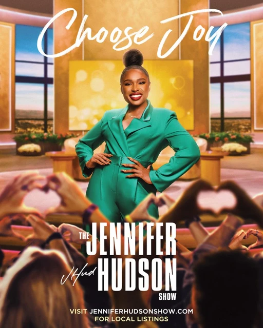 Jennifer Hudson in green suit posing on talk show set with audience making heart hands. "Choose Joy" graphic overlay.