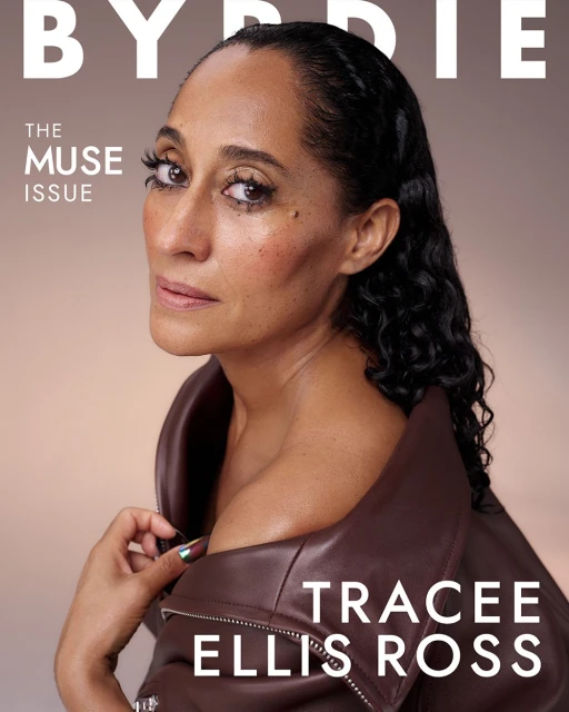 Close-up of Tracee Ellis Ross on a magazine cover, wearing a brown leather jacket, with neutral makeup and a sleek, wet hairstyle.