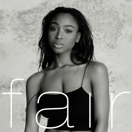 Monochrome portrait of a young African-descent woman with dark hair wearing a black top, set against a grey, textured background.
