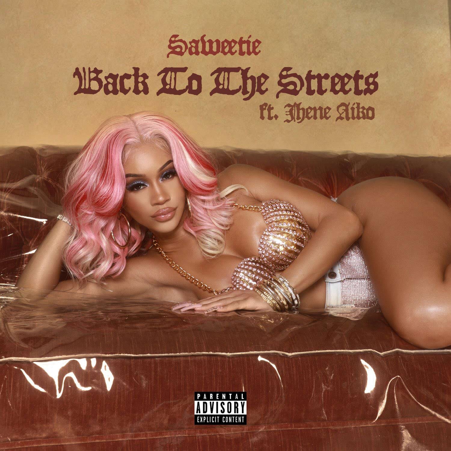 Saweetie laying on a couch with gold jewelry and a pink wig, album cover for "Back To The Streets" ft. Jhene Aiko.