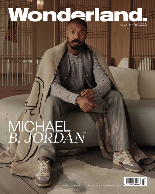 Michael B. Jordan on the cover of Wonderland. magazine, Autumn/Fall 2020 issue, wearing a gray sweater and draped with a patterned blanket.