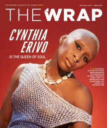 Portrait of Cynthia Erivo wearing a silver mesh top and pearl necklace against a red background for magazine cover by Blair Caldwell