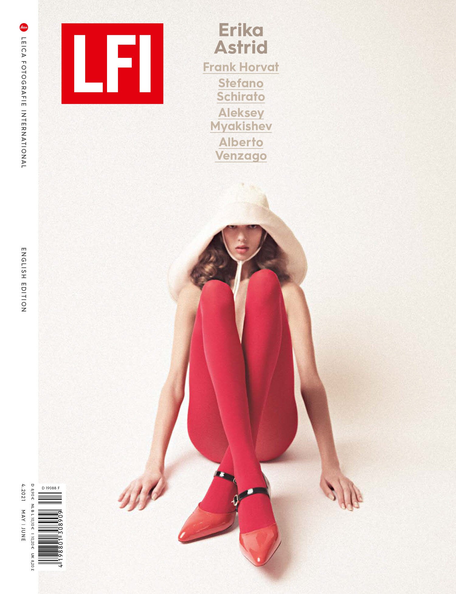 A woman in red tights and shoes sitting on the floor wearing a large hat, photographed for the cover of Leica Fotografie International.