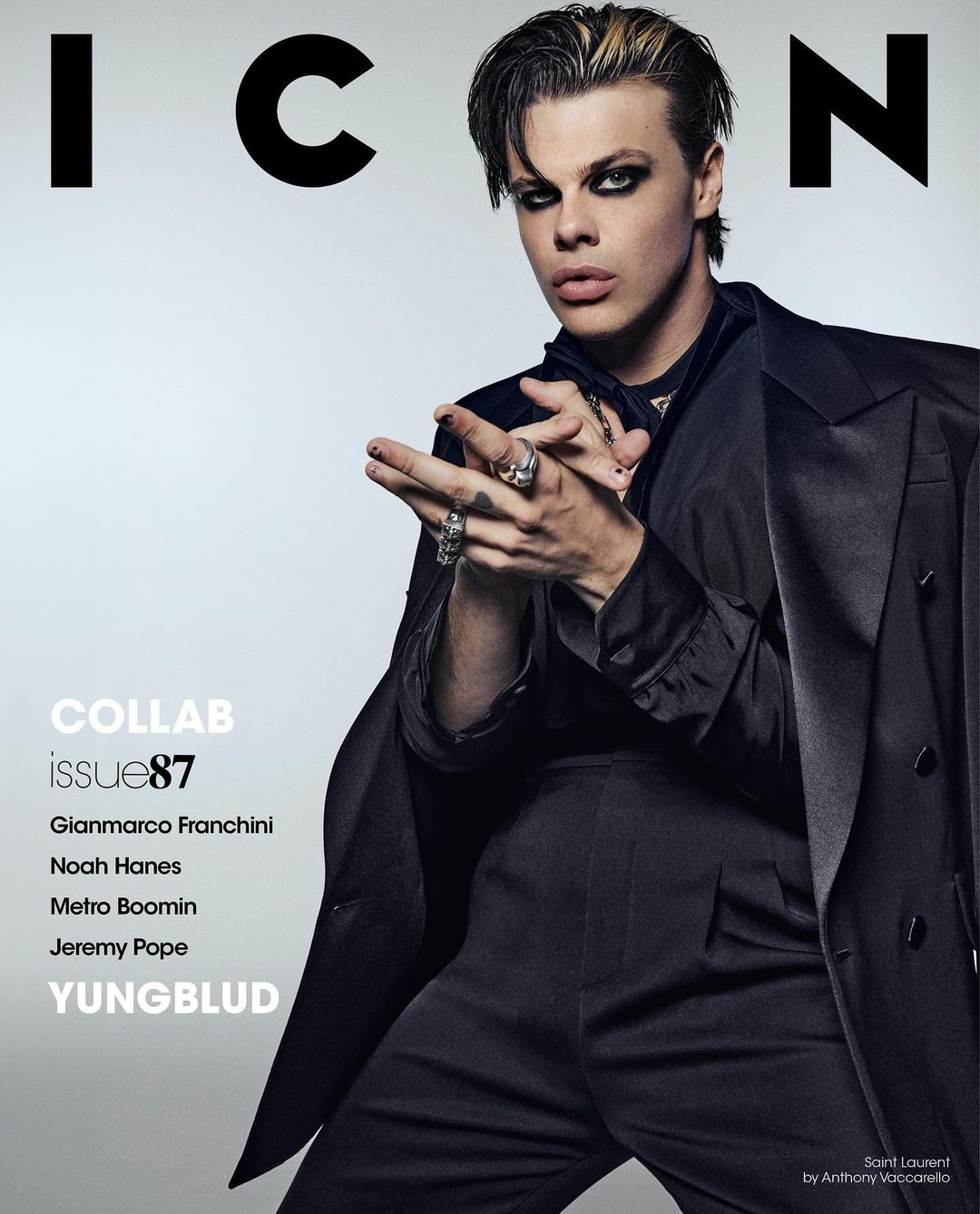 Yungblud on ICON magazine cover, Issue 87. Adult male in black suit with dramatic eye makeup and blond-streaked hair poses indoors.