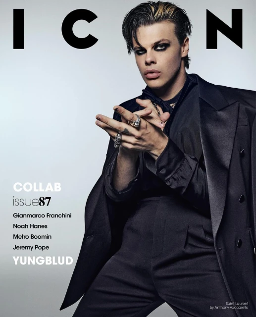 Yungblud on ICON magazine cover, Issue 87. Adult male in black suit with dramatic eye makeup and blond-streaked hair poses indoors.