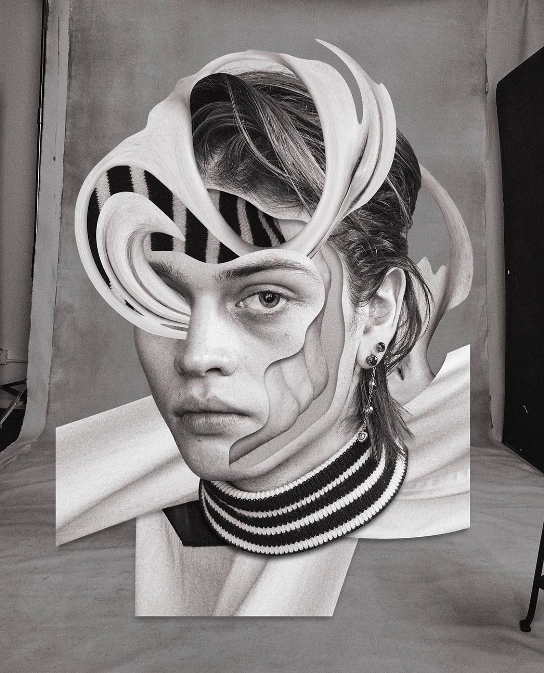 Monochrome portrait of a person with a striped top, digitally manipulated with carved-out sections and an added layered headpiece.