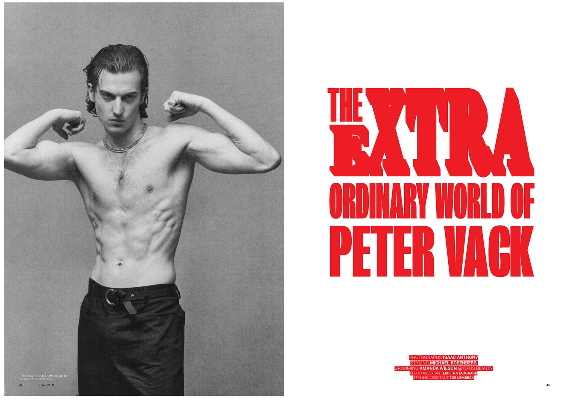 Editorial fashion shot of a shirtless adult male flexing his arms in a photo studio; the image has a magazine cover on the right side.