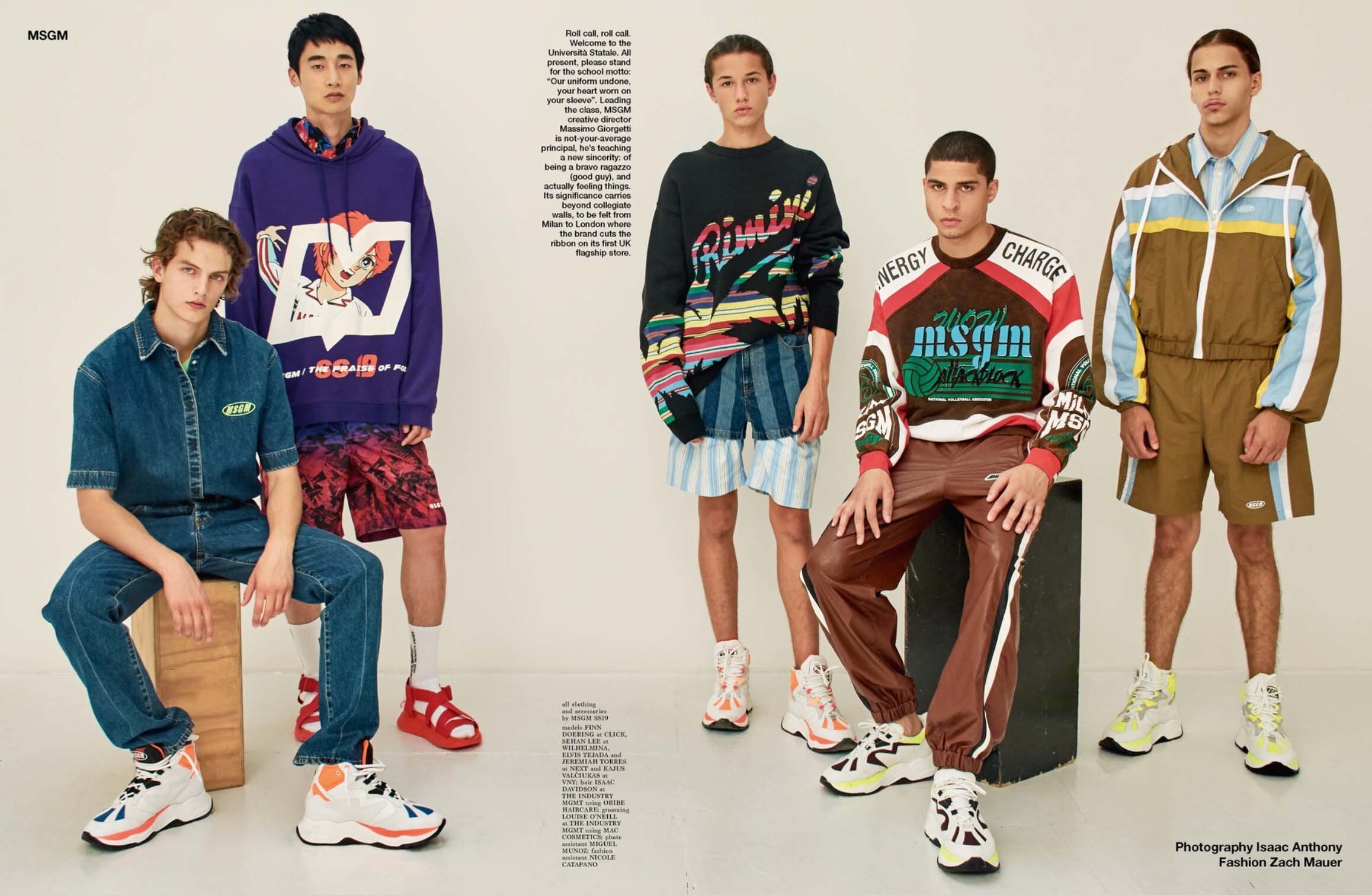 Five young adult male models pose in a photo studio, showcasing streetwear fashion with graphic hoodies, sweaters, shorts, pants, and sneakers.