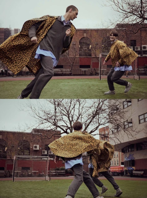 Two adult men in a grass field playing a game; one man runs toward the camera, wearing a leopard-print coat, on an overcast day.