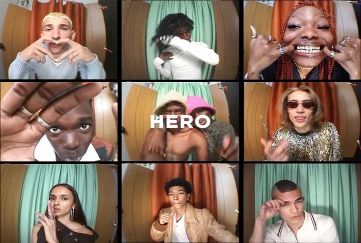 A grid of nine video call screens featuring diverse individuals making hand gestures, wearing various outfits, and engaging with the camera.