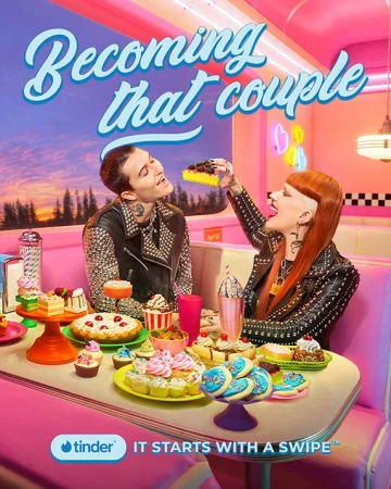 A couple enjoys dessert inside a retro diner in a bright, vintage-styled ad for Tinder, which is visible in the lower left corner.