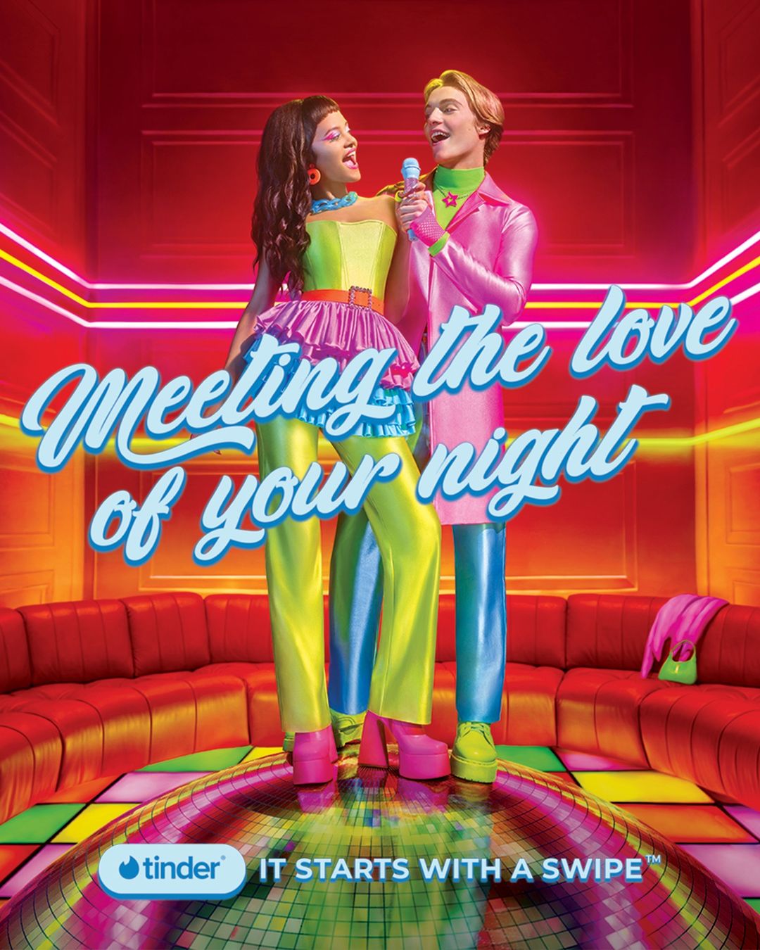 Two models pose with a microphone in a retro karaoke room. The promotional shot features bright, neon colors and a disco floor pattern.
