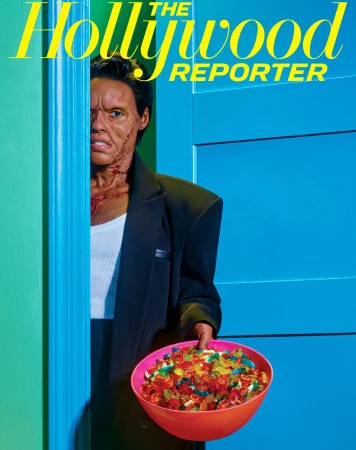Magazine cover featuring a man with theatrical makeup holding a bowl of gummy candies in front of a turquoise door.
