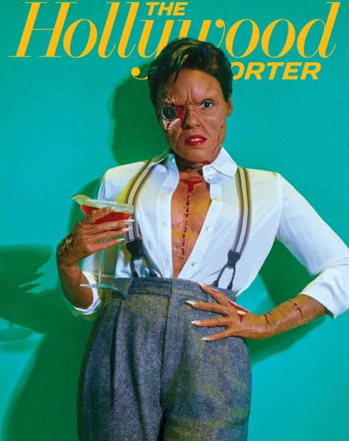 The Hollywood Reporter magazine cover featuring a person with special effects makeup holding a cocktail against a teal background.