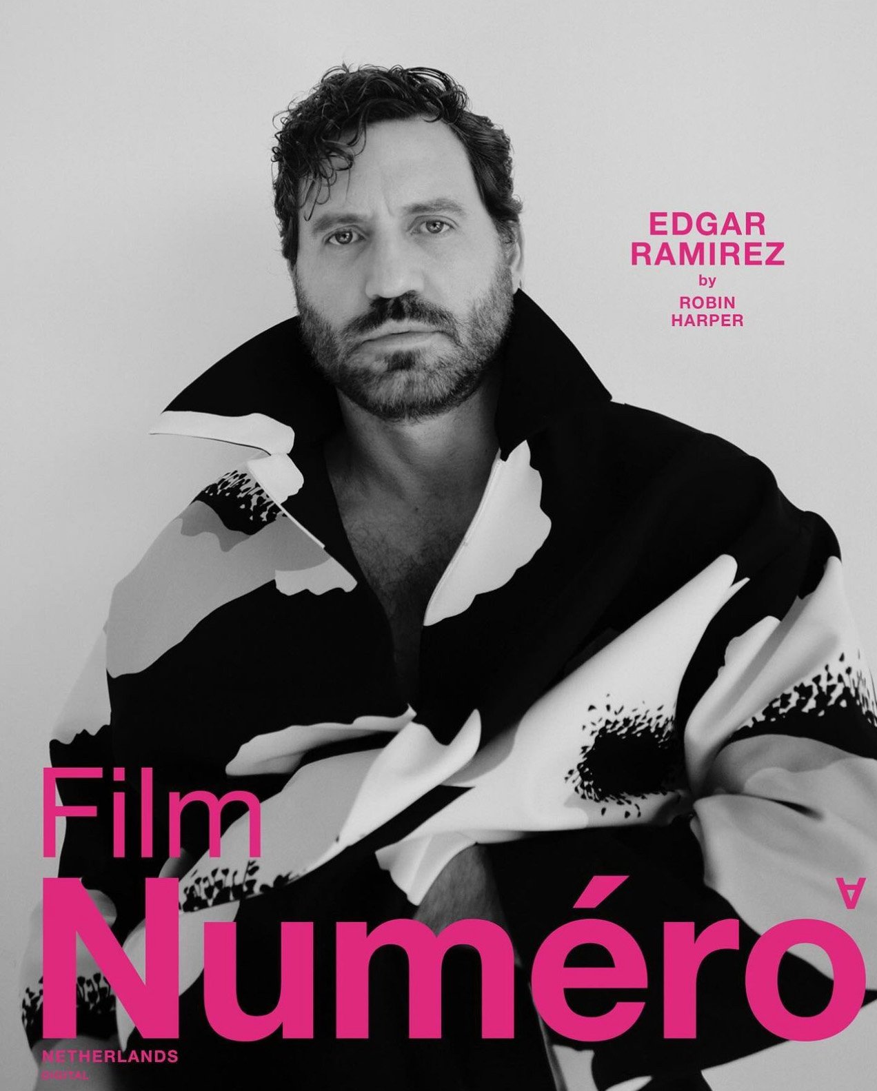 Portrait of Edgar Ramirez in a black and white patterned coat, featured in Numero Netherlands magazine against a white background.