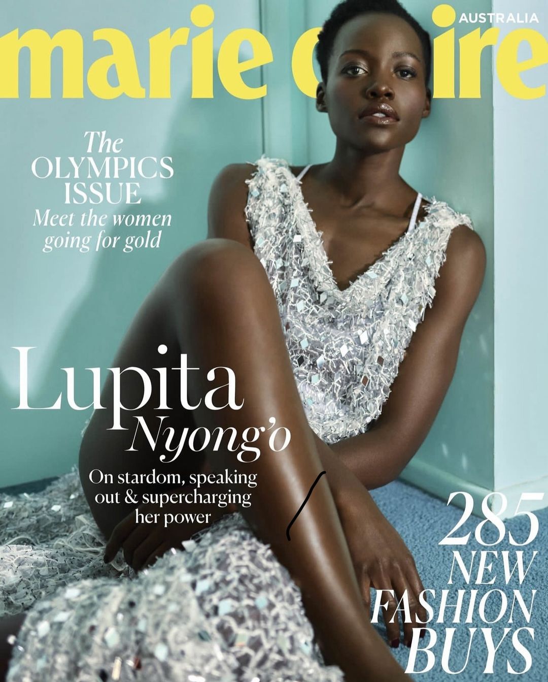 Marie Claire Australia cover featuring Lupita Nyong'o in a shimmering dress, seated against a soft blue backdrop. Fashion and celebrity focus.