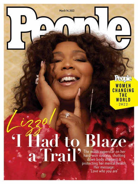 Lizzo smiles on the cover of People Magazine, March 14, 2022, wearing a red sequined jacket with statement rings and earrings.