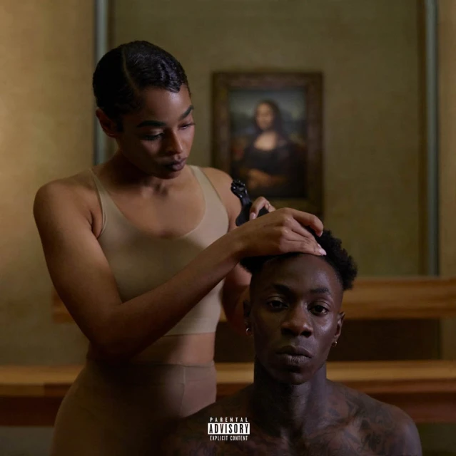 Album cover featuring a woman styling a man's hair in front of a painting, creating an intimate and artistic portrait.