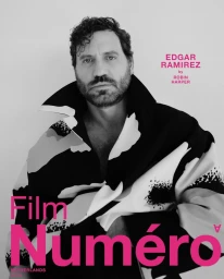 Portrait of Edgar Ramirez wearing a patterned jacket against a white background, photographed by Robin Harper.
