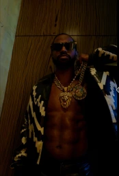 Big Sean wearing sunglasses, gold chains, and a patterned jacket photographed by Robin Harper in Los Angeles