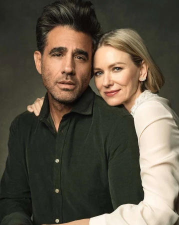 Close-up portrait of Bobby Cannavale and Naomi Watts posing closely together against a dark textured background
