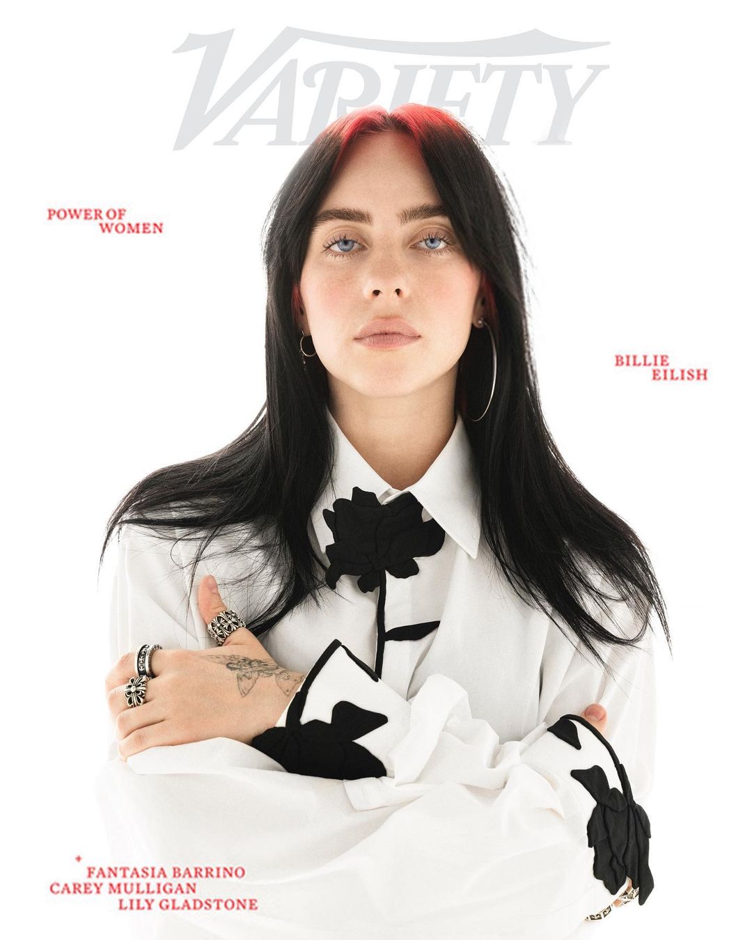 Close-up magazine cover featuring Billie Eilish wearing a white shirt with a black flower, against a white background with magazine text.
