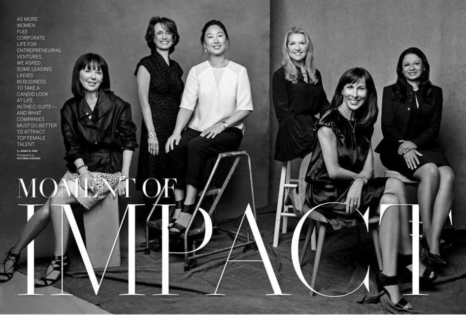 Black-and-white image shows six women seated and standing in a photo studio, dressed in professional attire, promoting female leadership.