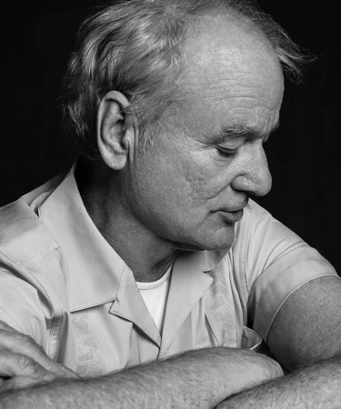 Black and white portrait of Bill Murray with arms crossed, captured in profile by Victoria Stevens.