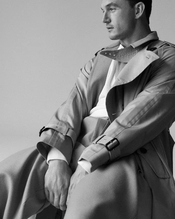 Portrait of a man wearing a trench coat photographed by Victoria Stevens in monochrome