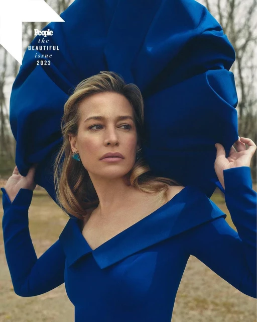 Portrait of Robin Wright for People Magazine's The Beautiful Issue 2023, wearing a blue dress and turquoise earrings outdoors.