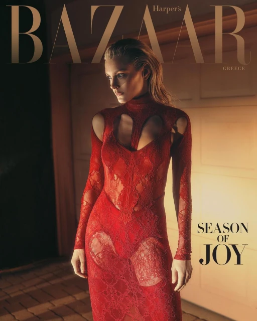 Fashion editorial cover of Harper's Bazaar Greece featuring a fair-skinned fashion model in a red lace dress with cutout details, indoors.