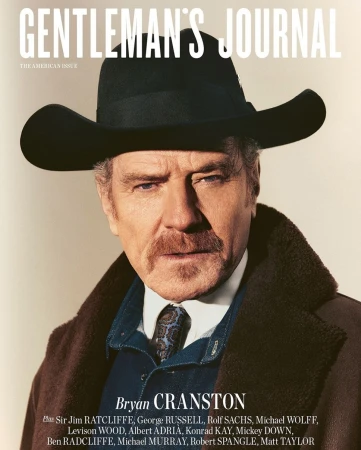 Magazine cover featuring Bryan Cranston in a black cowboy hat and brown coat, set against a neutral backdrop with magazine text overlay.
