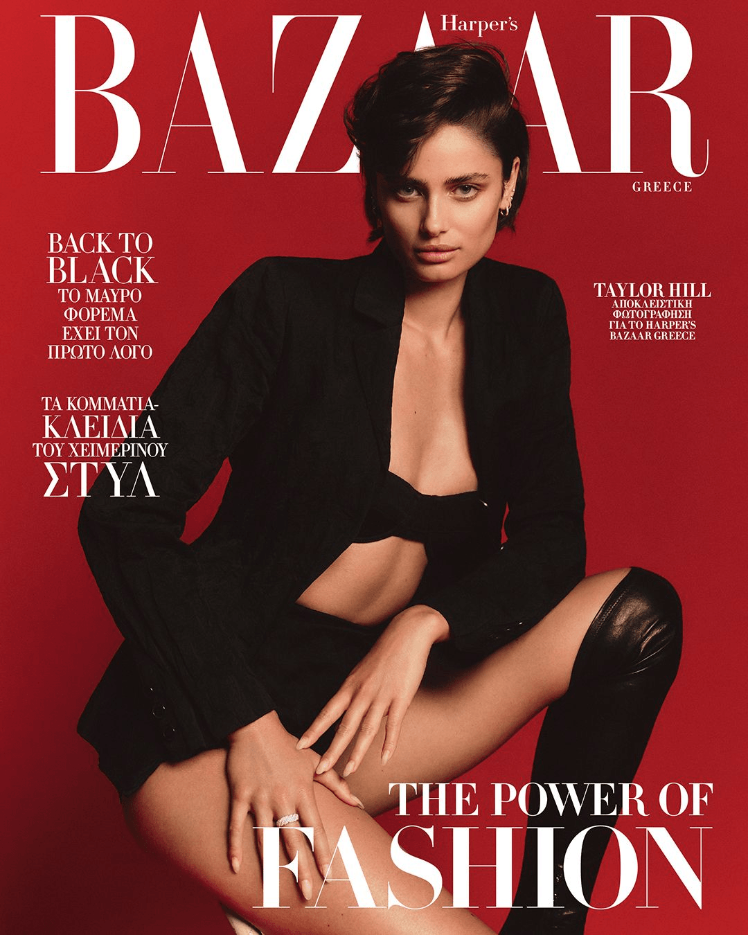 Magazine cover of Harper's Bazaar Greece featuring Taylor Hill in a black blazer and thigh-high boots against a red backdrop.