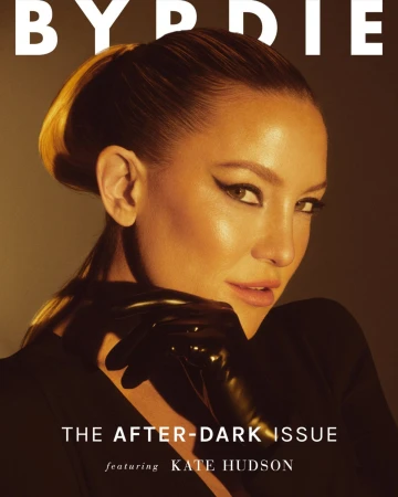 Close-up portrait of Kate Hudson wearing dark gloves and winged eyeliner against a warm lit background by Jonny Marlow