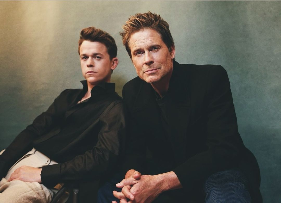 Rob Lowe and John Owen Lowe posing together against a textured green background in a portrait by Jonny Marlow