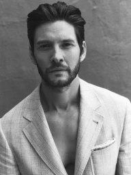 Portrait of Ben Barnes with a beard wearing a light-coloured pinstripe blazer photographed by Jonny Marlow in Los Angeles