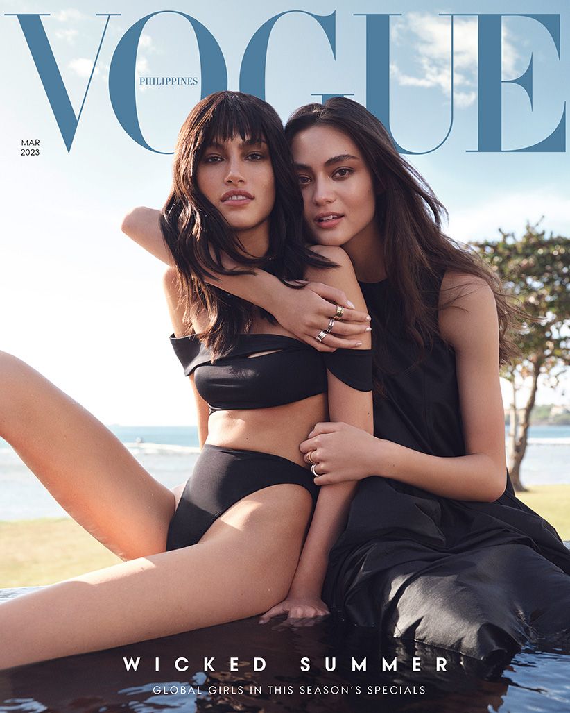 Vogue Philippines magazine cover with two young women in black swimwear and dress posing outdoors on a sunny day with ocean backdrop.