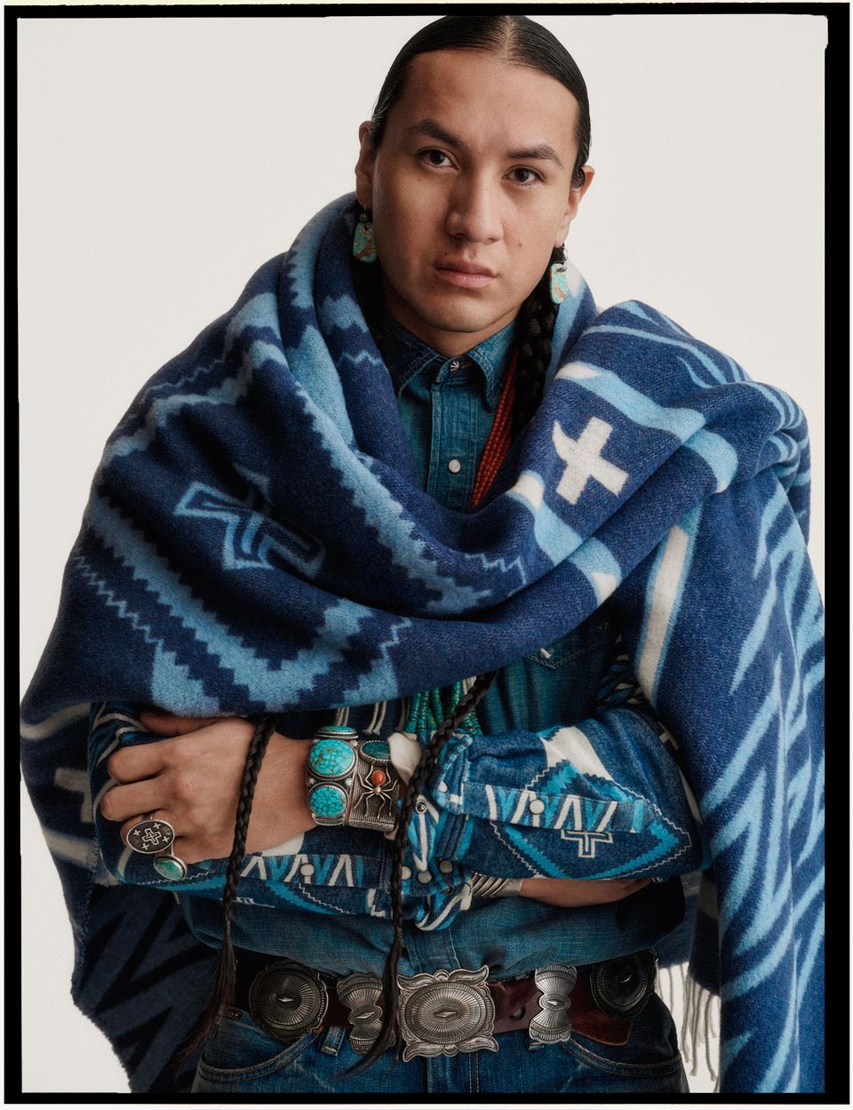 Portrait of a man wearing a blue patterned blanket and denim shirt with turquoise jewelry by photographer Sharif Hamza