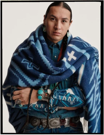 Portrait of a man wearing a blue patterned blanket and denim shirt with turquoise jewelry by photographer Sharif Hamza