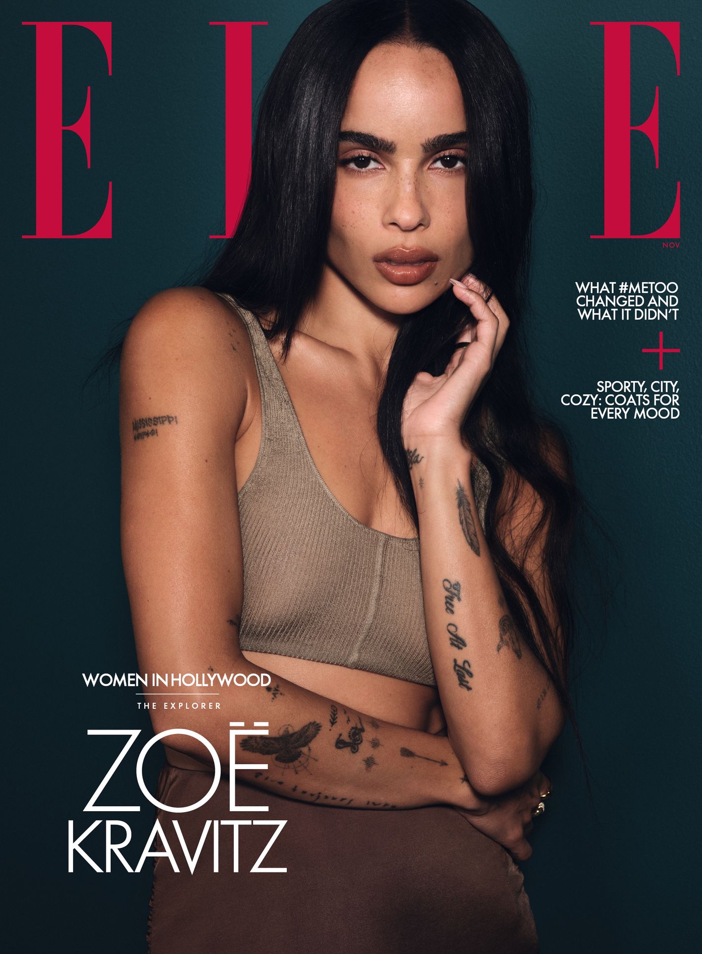 Elle magazine cover featuring Zoë Kravitz looking at the camera with a neutral expression, with dark hair, brown bralette, and dark background.
