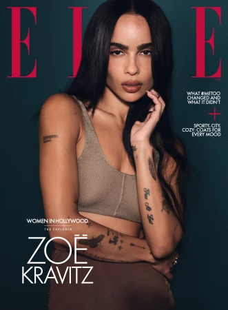 Elle magazine cover featuring Zoë Kravitz looking at the camera with a neutral expression, with dark hair, brown bralette, and dark background.