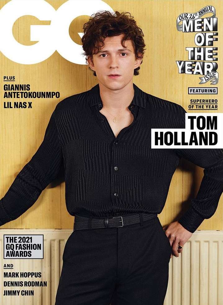 GQ Magazine cover featuring Tom Holland in a black button-down shirt and pants against a yellow backdrop, promoting 'Men of the Year'.
