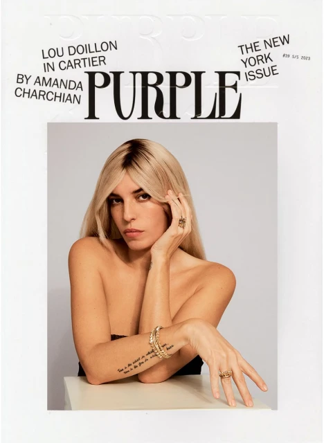 Magazine cover featuring a blonde woman with jewelry, including rings and a bracelet, with the masthead 'PURPLE' and various cover lines.