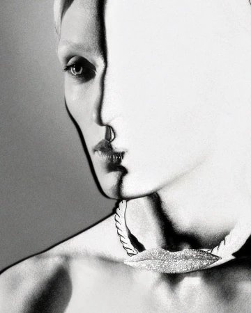 Close-up monochrome portrait of a model wearing a textured choker necklace by photographer Amanda Charchian.