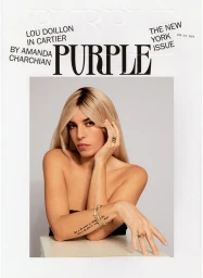 Lou Doillon with blonde hair wearing gold rings and bracelets against a white background
