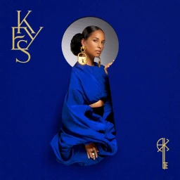 Alicia Keys wearing a royal blue draped top and gold padlock earrings against a textured dark blue background.