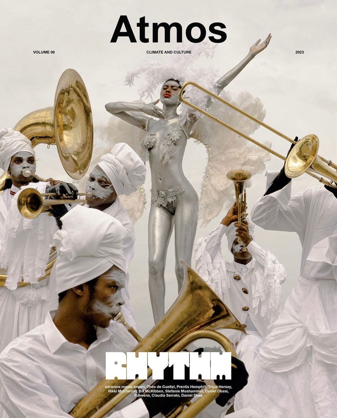 Magazine cover features a silver-painted model and a brass band in white, promoting 'Atmos' magazine with 'Rhythm' as the featured theme.